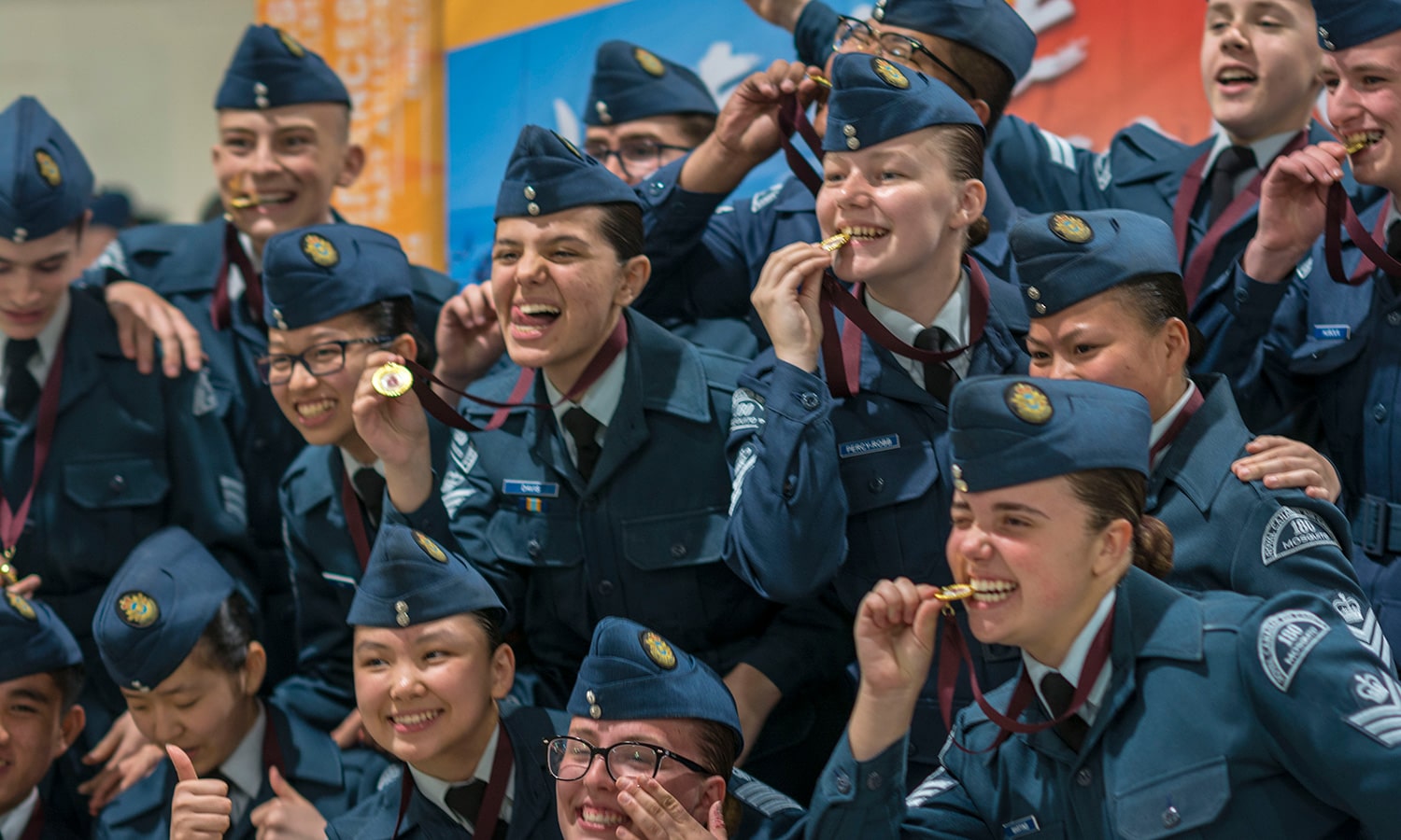 Cadets celebrate earning medals at an event