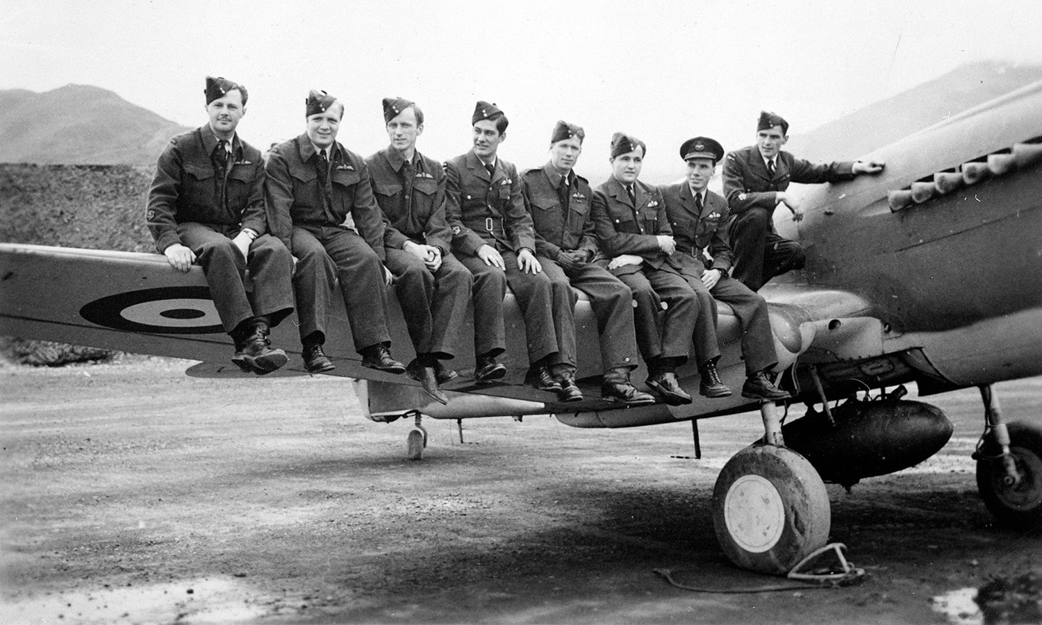 Members sitting on plane wing