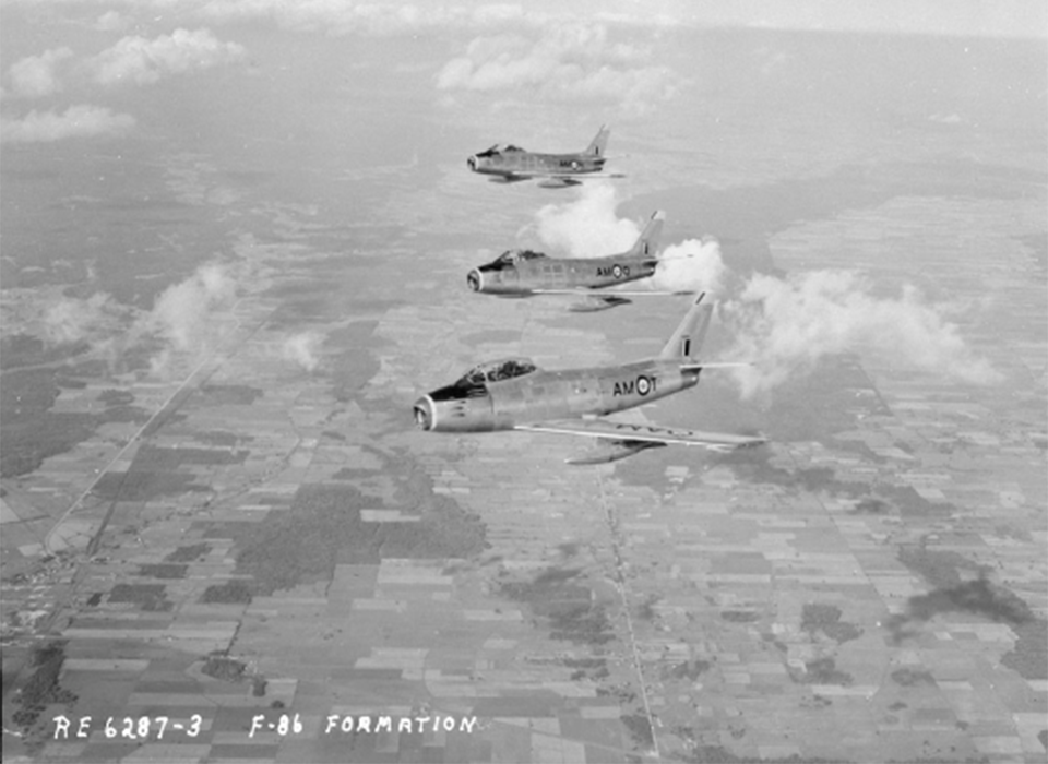 Three RCAF F-86 Sabres from 439 Squadron fly over England